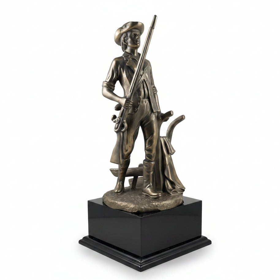 Bronze statue of a figure holding a rifle on a black base against a white background