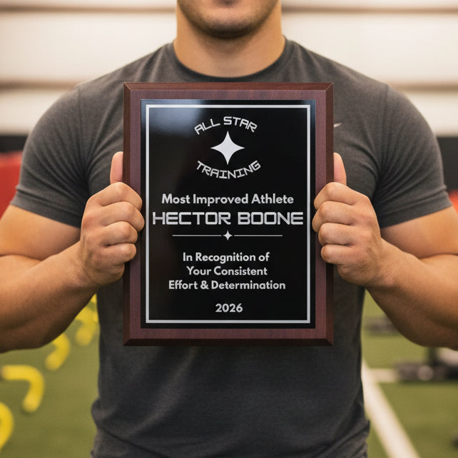 Man holding personalized walnut plaque with black and silver metal plate awarded for Most Improved Athlete - lifestyle photo