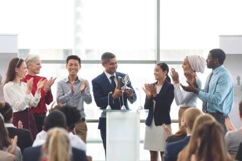 Business owner holding award